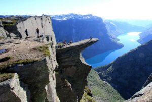 A rock formation that sticks out from a mountain about two thousand feet above a lake in Norway.