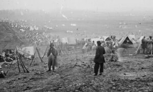 An old photo taken during the battle of Nashville that shows tents and two men wearing disheveled clothing.