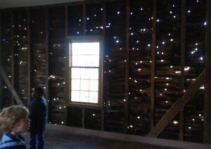 A photo taken from inside an outbuilding at Carter House in Franklin that shows about a hundred holes in the wall that were made during the Battle of Franklin in 1864.