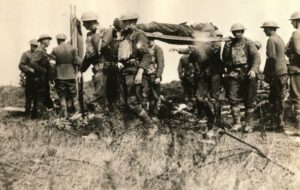 A group of World War I soldiers carry a wounded comrade on stretcher