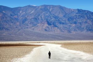 A mountain in the distance and a desert in the foreground