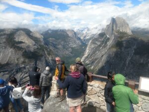 The gorgeous view at Yosemite National Park shows half dome and the deep canyon beside it. 