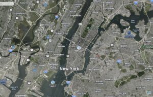 A satellite image of New York City shows the locations of the East River, the Hudson River, the Statue of Liberty, the Empire State building, and other famous landmarks. 